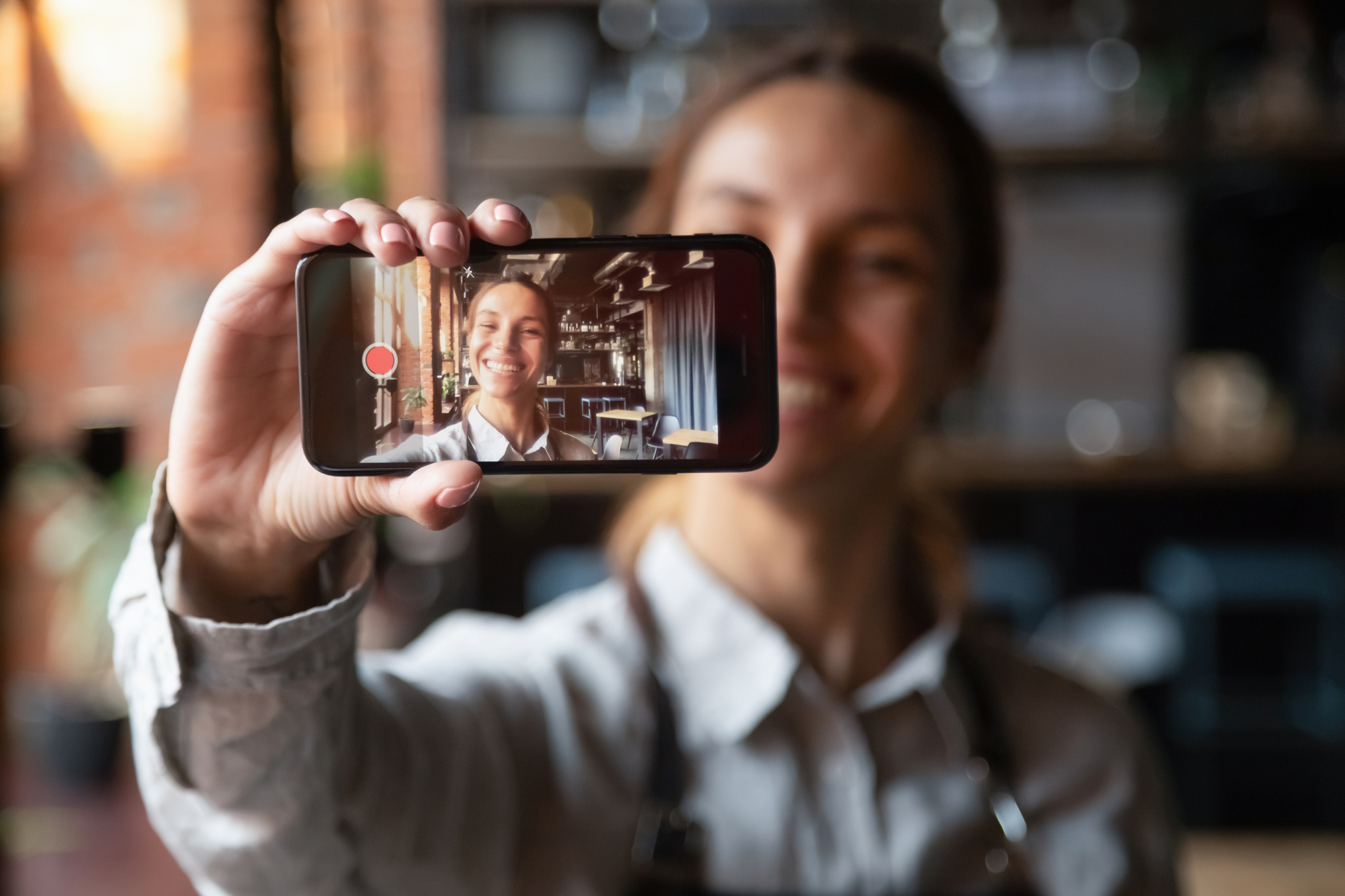 instagram_business_ideas A young vlogger holding smartphone recording video blog , one of the best instagram business ideas