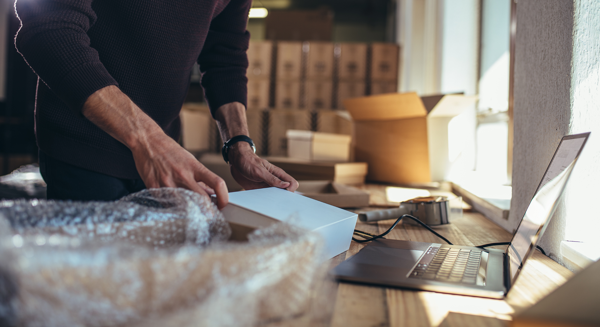online_marketplace_sell_products Small business owner packing cardboard box to sell in an online marketplace