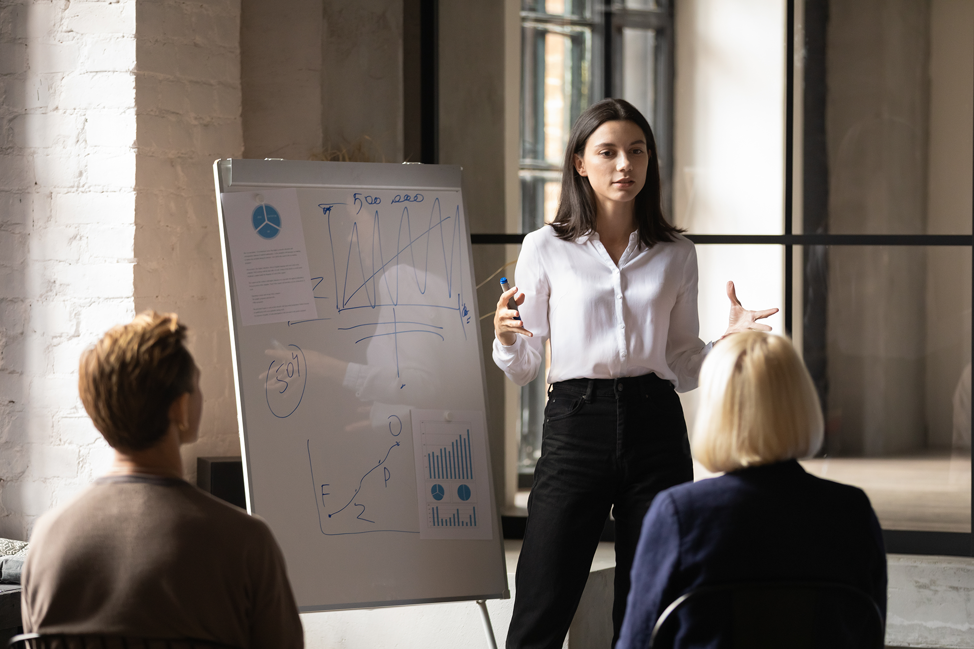 word_of_mouth_marketing Confident young woman uses a white board practice word of mouth marketing