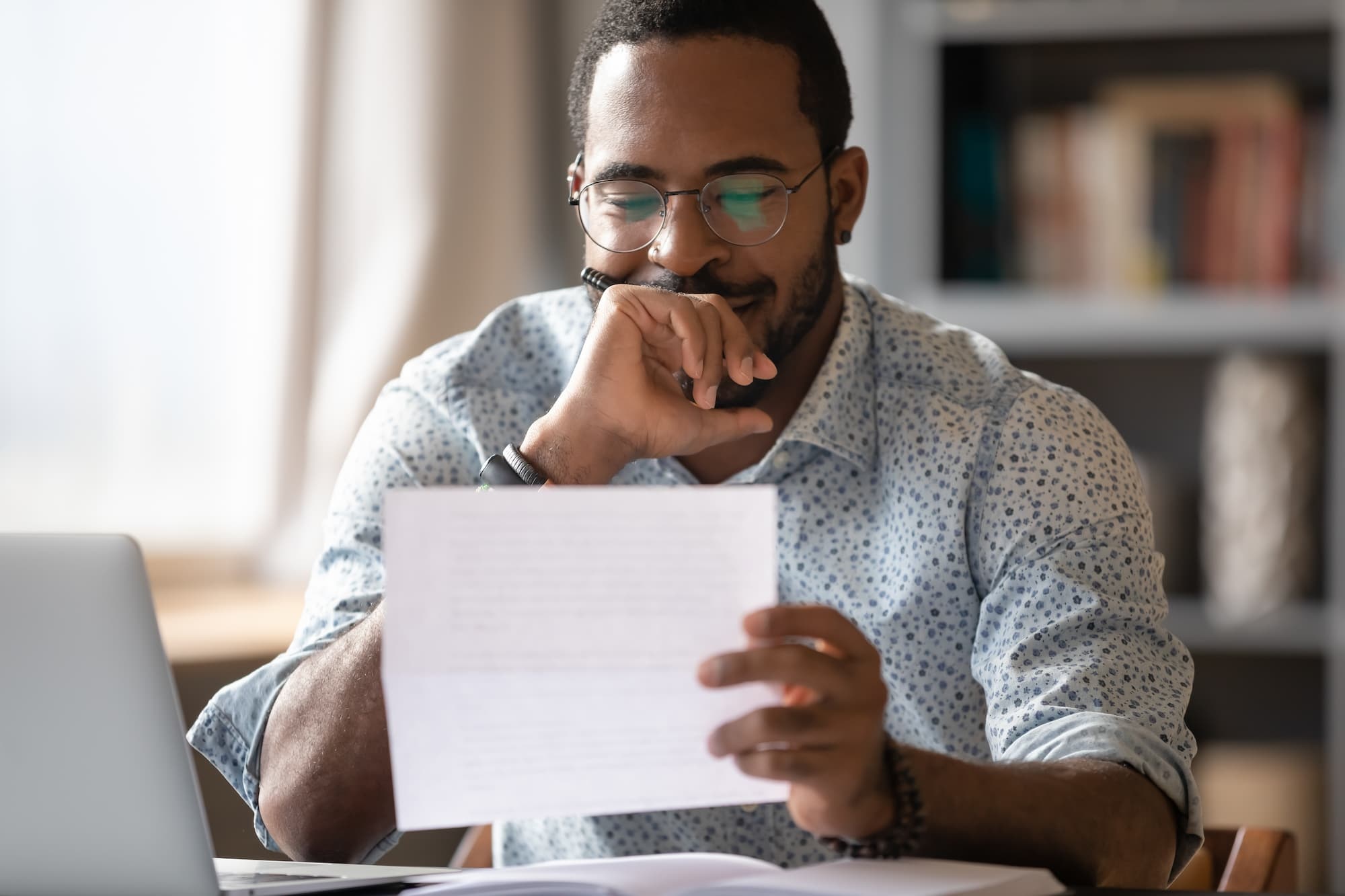 grant_vs_loan Man looking at a grant application when deciding between grant vs loan