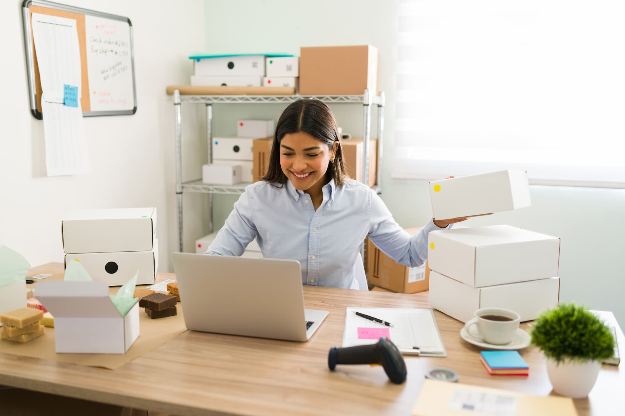 incorporation_costs A woman sits at her desk in front of a laptop and packs boxes after learning about incorporation costs